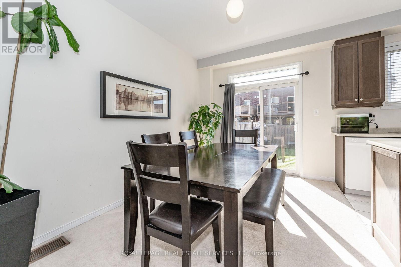 A dining room with a table and chairs.