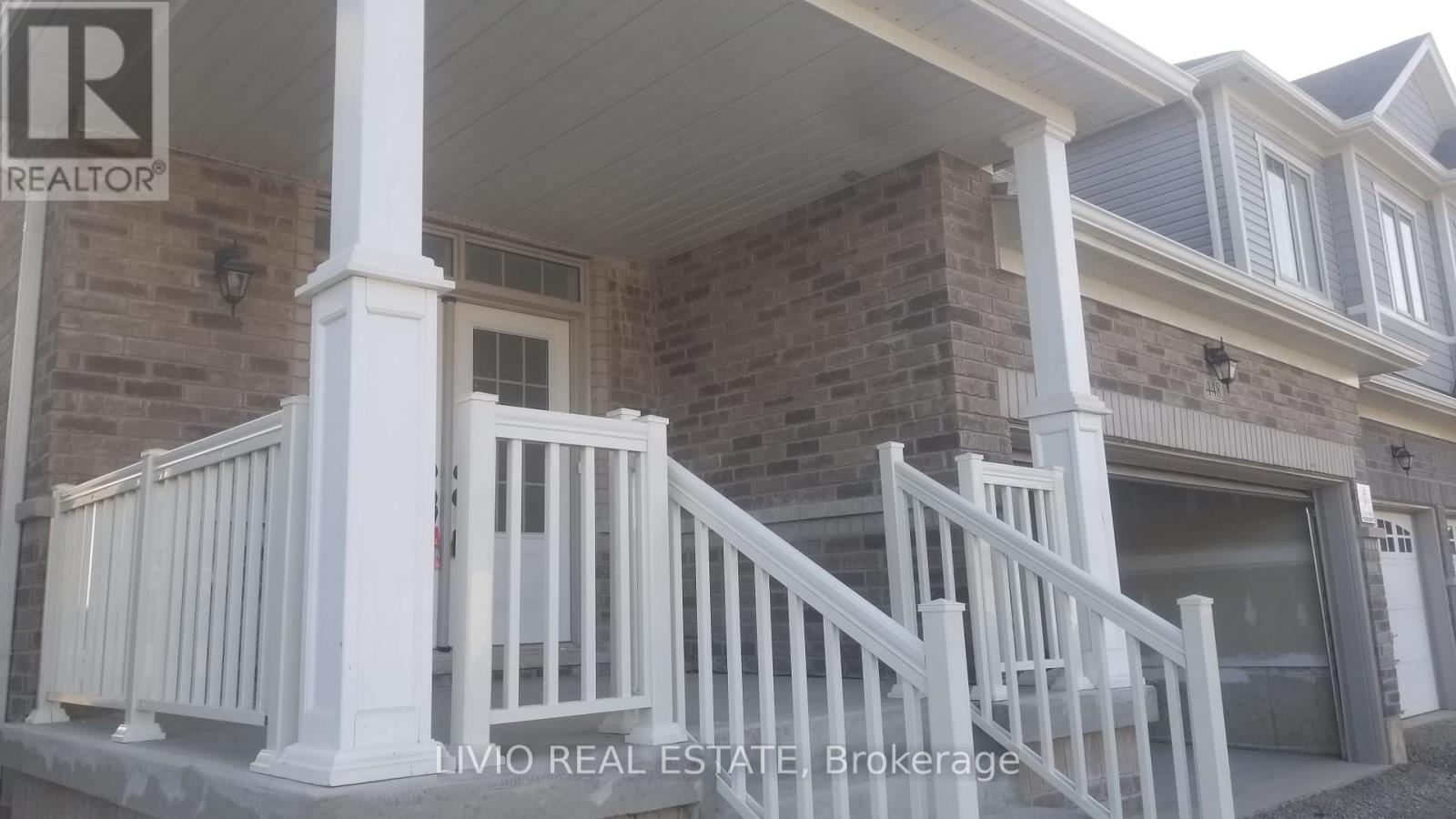 A house with a realtor sign on the front.