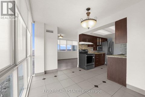 A kitchen with a black oven and a brown counter.