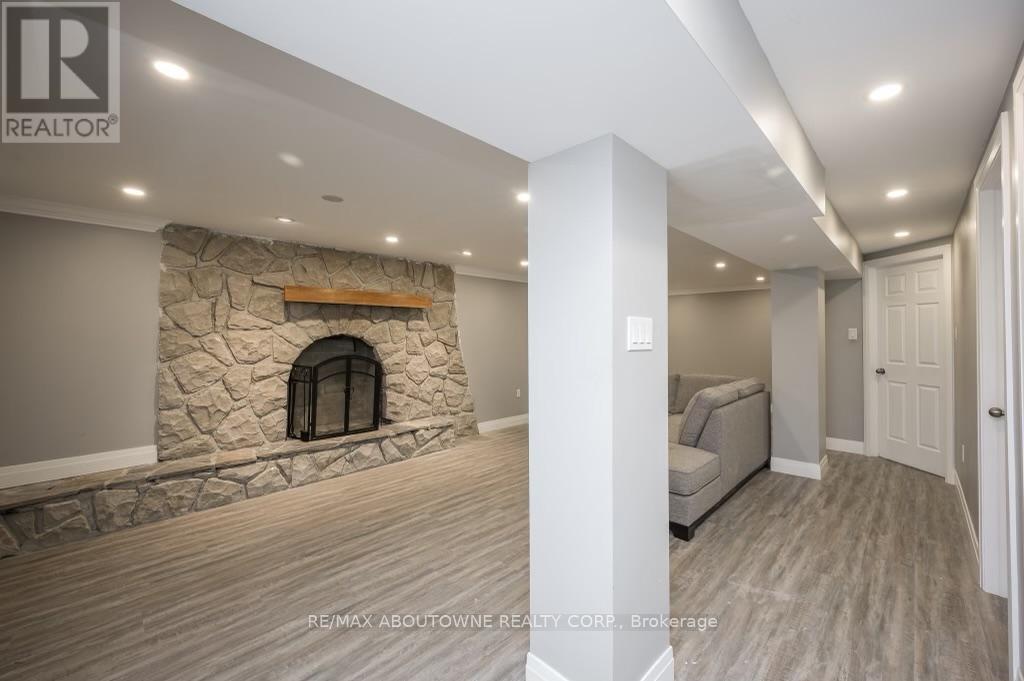 A stone fireplace is built into a wall in a spacious room.