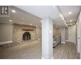 A stone fireplace is built into a wall in a spacious room.