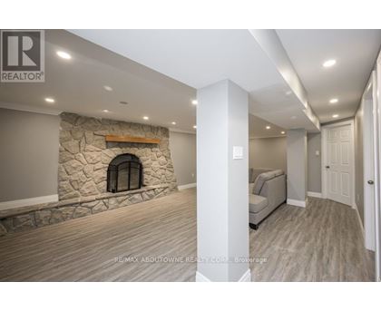 A stone fireplace is built into a wall in a spacious room.