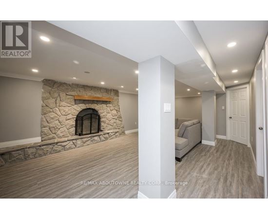 A stone fireplace is built into a wall in a spacious room.