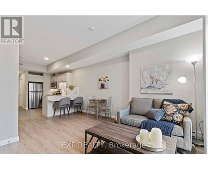 A living room with a grey couch and a wooden coffee table.