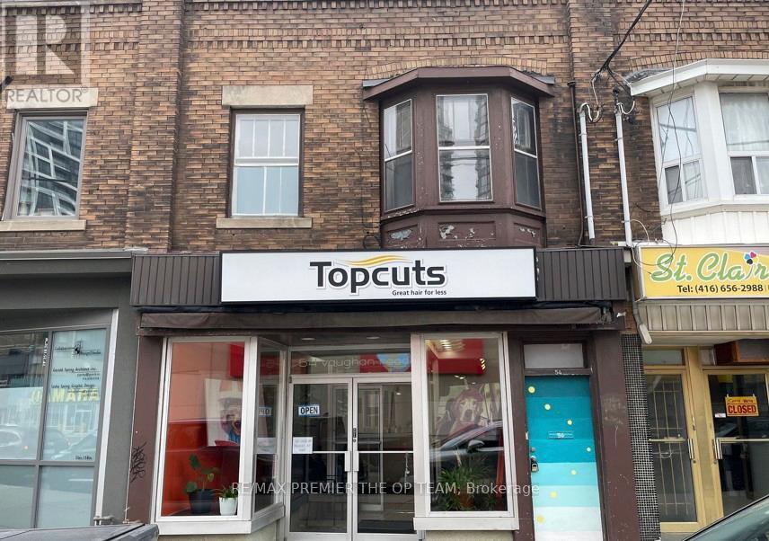 A storefront with a sign that says Topcuts.