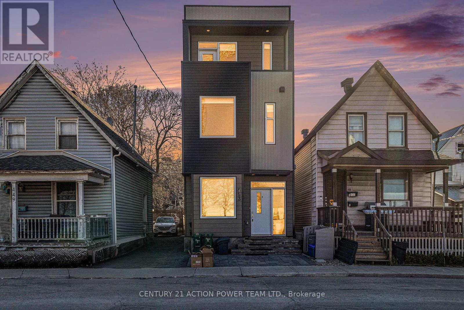 A modern house is being built in a residential area.