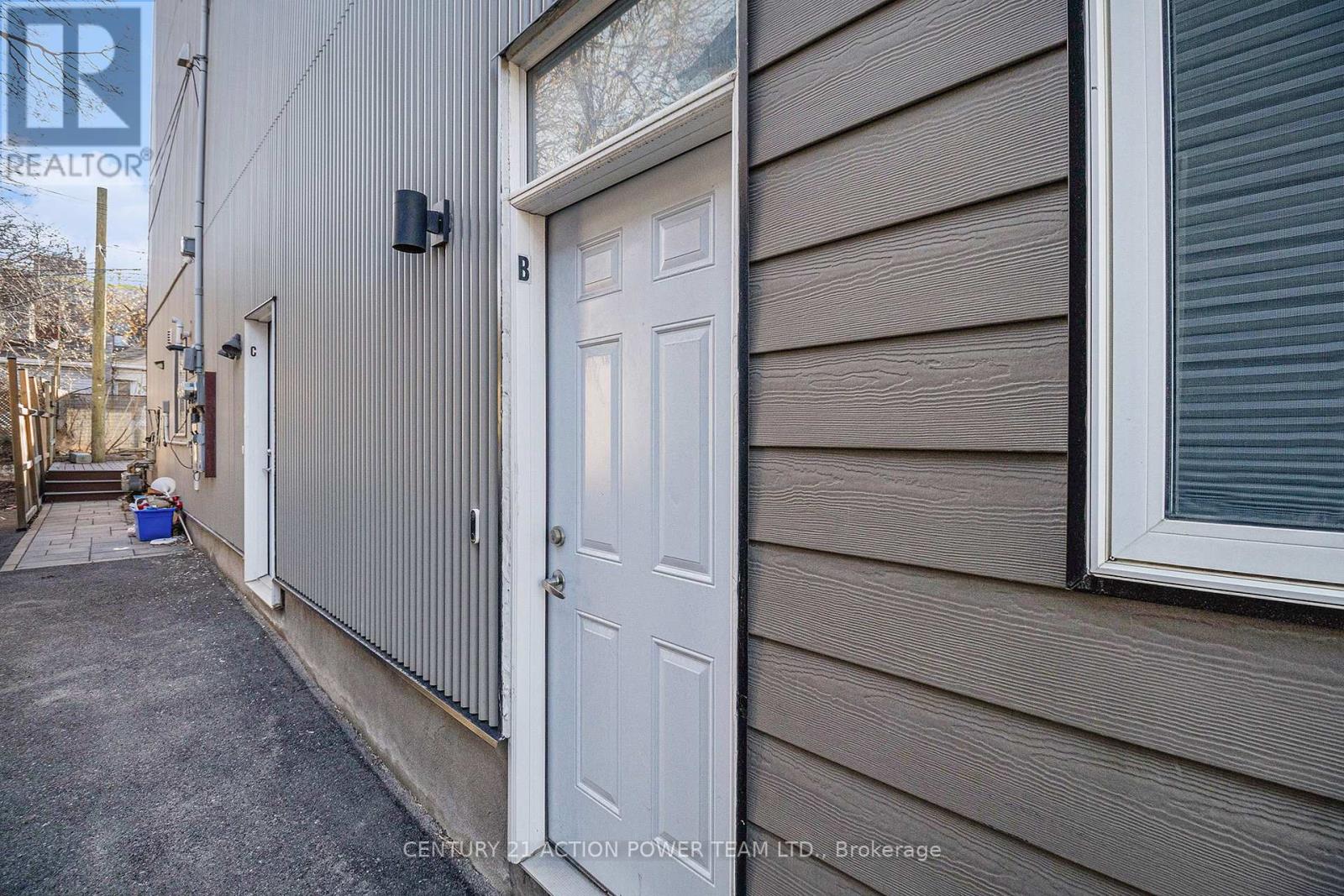 A white door is on the side of a house.
