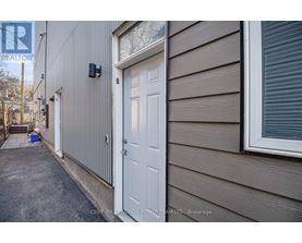 A white door is on the side of a house.
