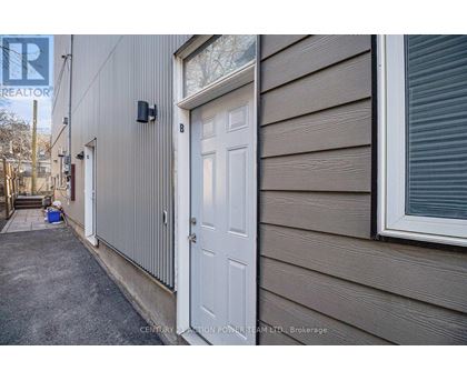 A white door is on the side of a house.