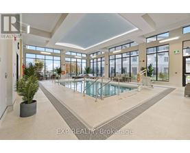 A large indoor swimming pool in a spacious room with a high ceiling and large windows.