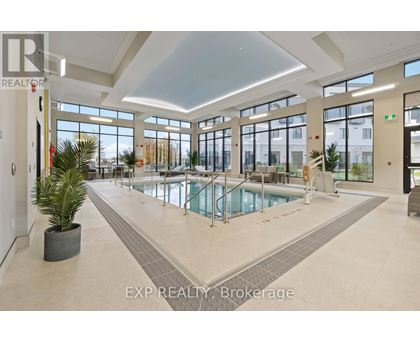 A large indoor swimming pool in a spacious room with a high ceiling and large windows.