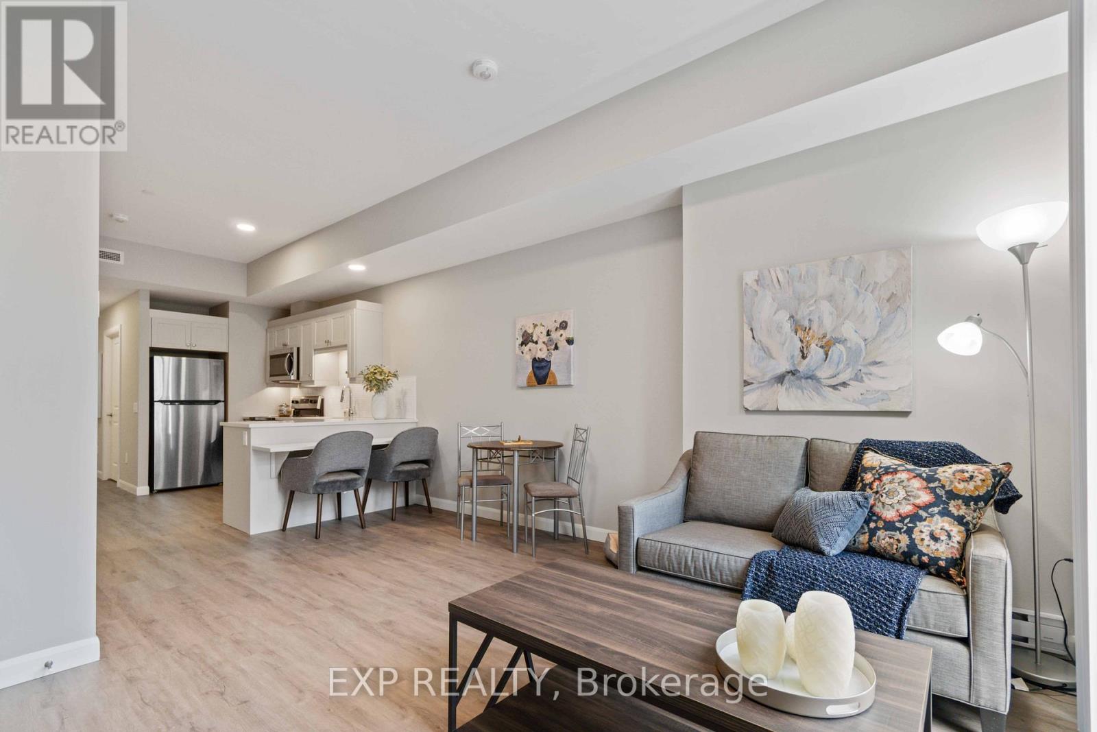 A living room with a grey couch and a wooden coffee table.