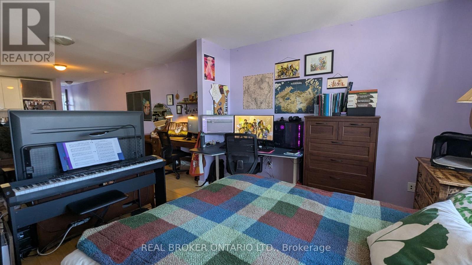 A bedroom with a bed, a piano, and a bookshelf.