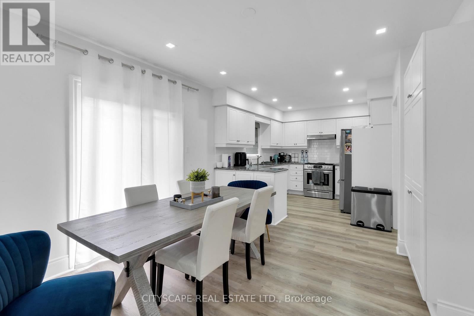 A modern kitchen with a dining table and chairs.