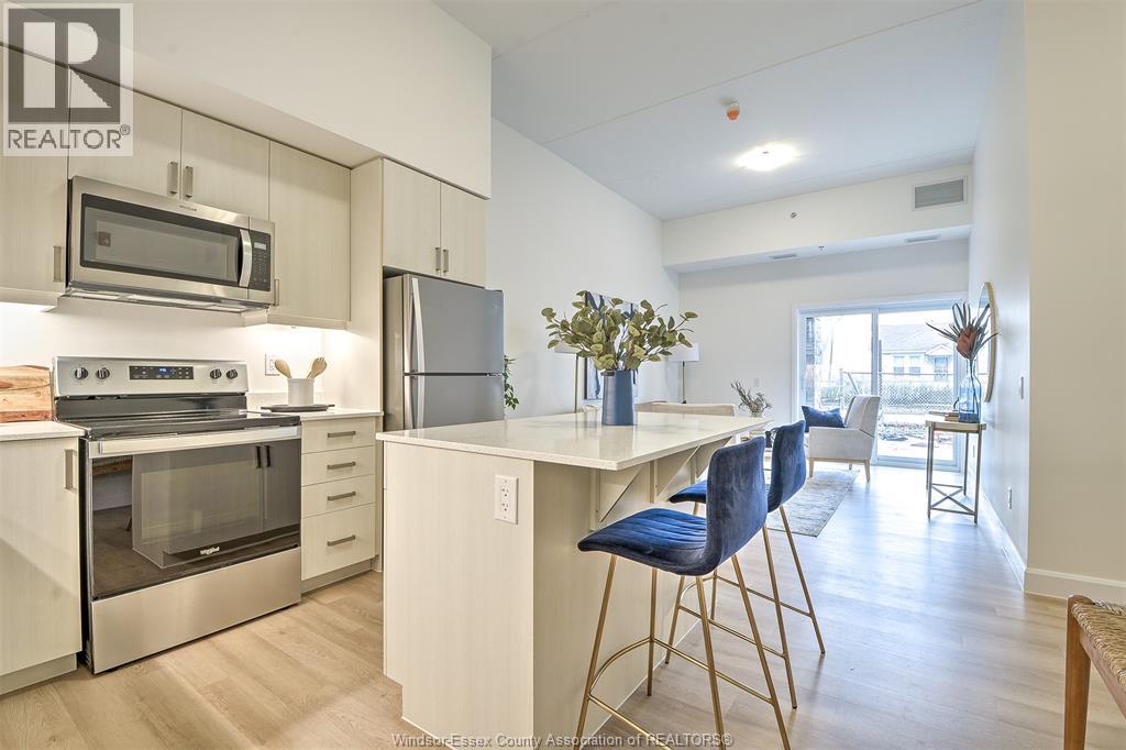 A spacious room with a sliding glass door and wooden flooring.