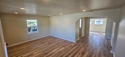 A room with wooden floors and a window.