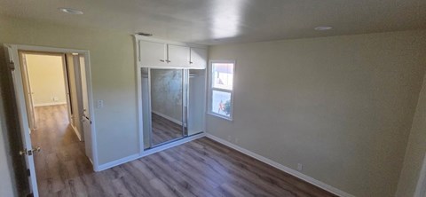 A room with a sliding glass door and a window.