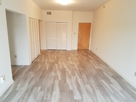 A room with a wooden floor and white walls.