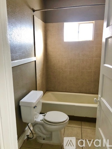 A small bathroom with a toilet and a bathtub.