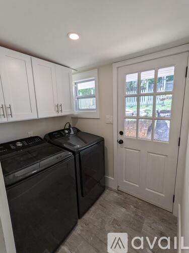 A small kitchen with a black dishwasher and a black stove top oven.