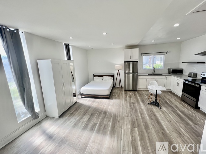 A modern kitchen with a dining table and chairs is available for rent.