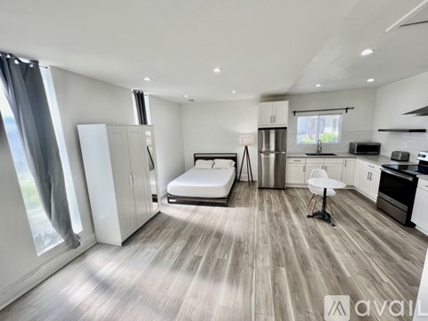 A modern kitchen with a dining table and chairs is available for rent.