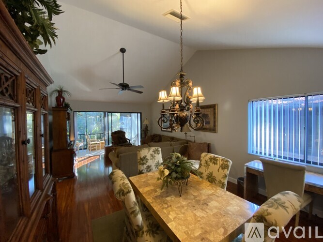 A dining room with a wooden table and chairs.