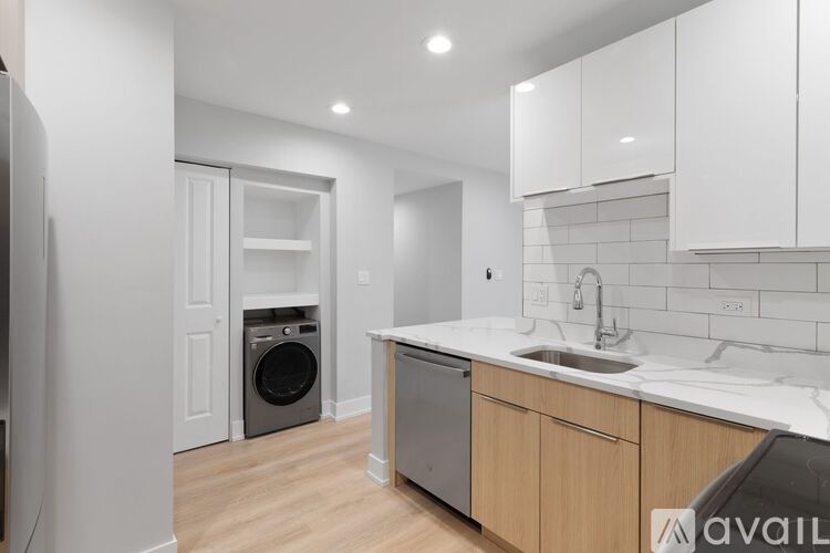 A modern kitchen with a washing machine and a dishwasher.