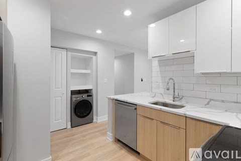 A modern kitchen with a washing machine and a dishwasher.