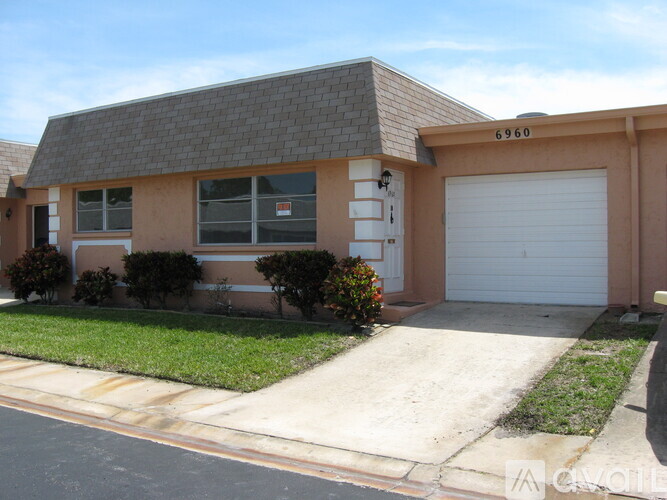 A house with the number 6960 on the garage door.