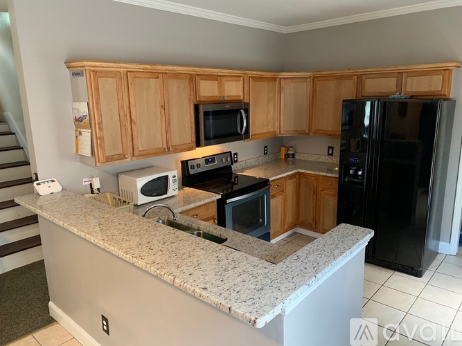 A kitchen with wooden cabinets and granite countertops.