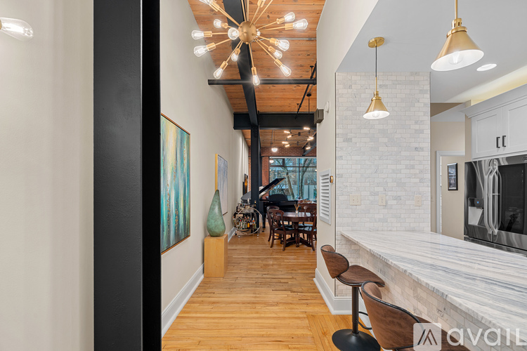 A modern interior with a wooden floor and a white brick wall.
