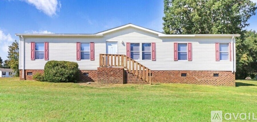 A house with a red and white exterior is available for rent.