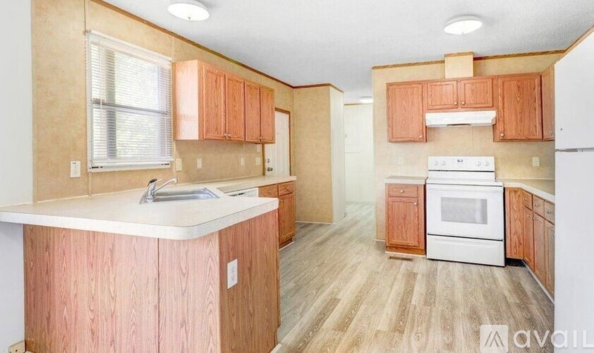 A kitchen with wooden cabinets and a white oven.