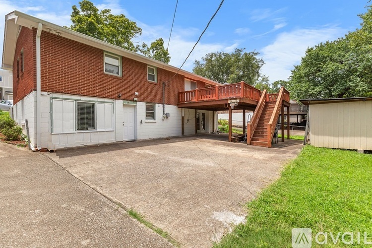 A house with a red brick exterior and a white door is for sale.