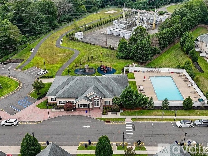 A view of a building with a pool and a playground.