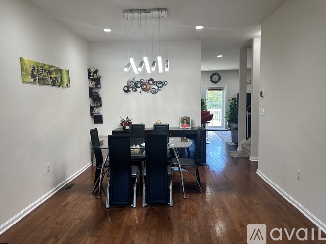 A dining room with a wooden table and chairs.