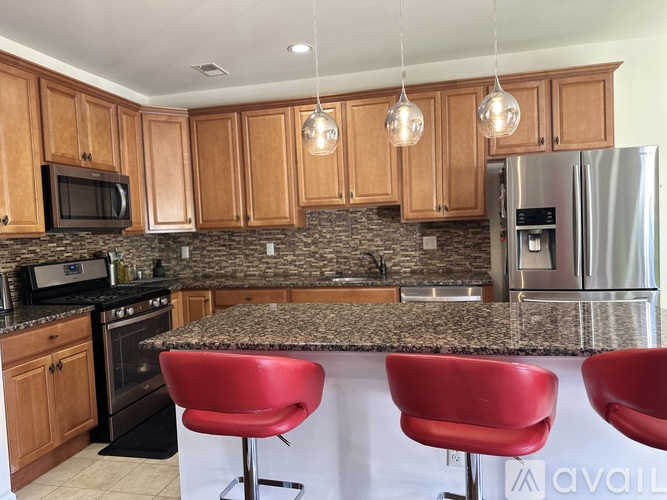 A kitchen with wooden cabinets and a granite countertop.