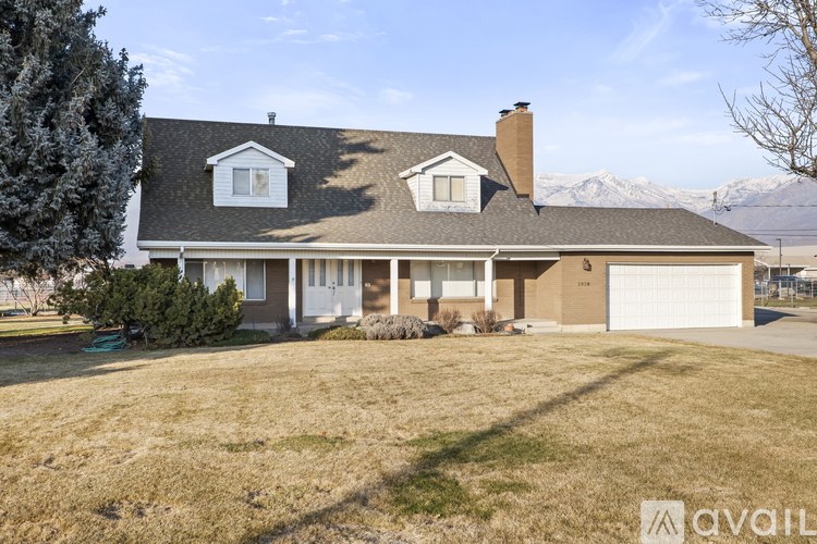 A house with a brown roof and a white garage door is for sale.