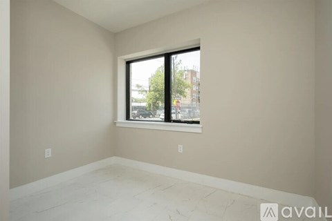 A room with a large window and a view of the outside.