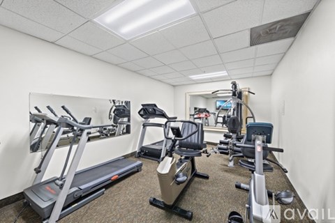 A well-equipped gym with treadmills, stationary bikes, and other exercise machines.