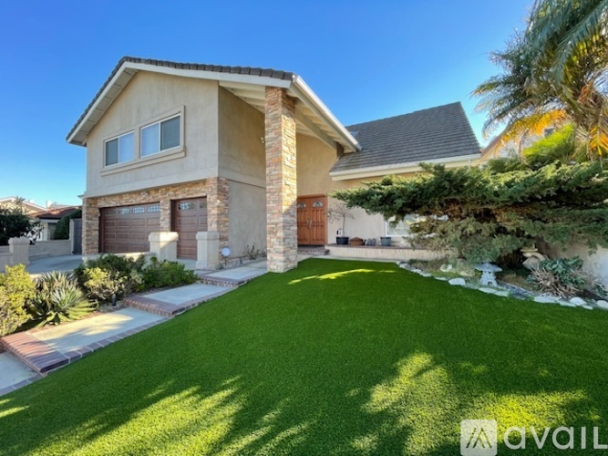 A house with a well-manicured lawn in front.