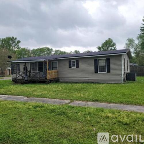A mobile home with a porch and a covered patio.