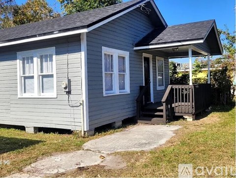 A small house with a porch and a covered entrance.