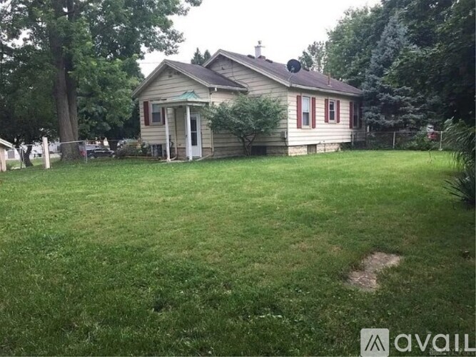 A house with a fence and a yard.