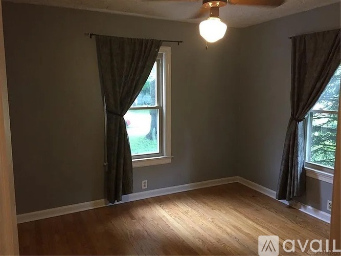 A room with a window and a ceiling fan.