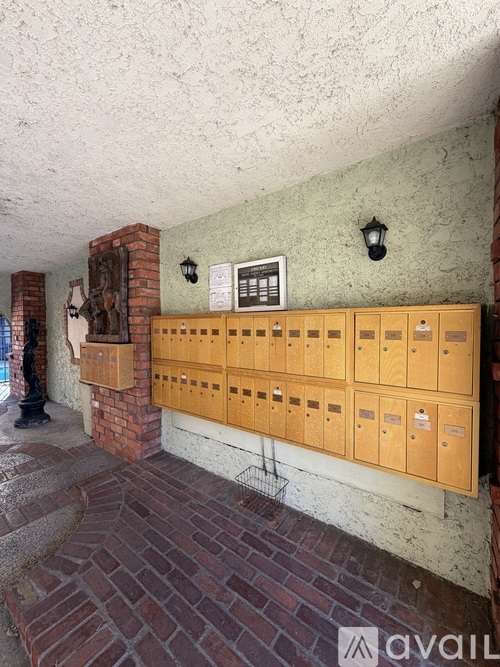 A row of mailboxes are on the side of a building.