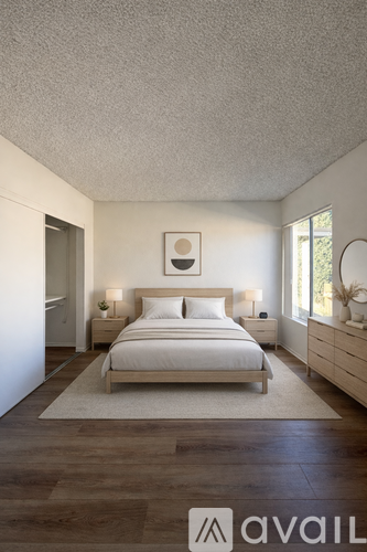 A bedroom with a bed, nightstands, and a rug.