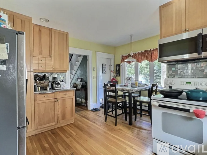 A kitchen with wooden cabinets and a refrigerator.