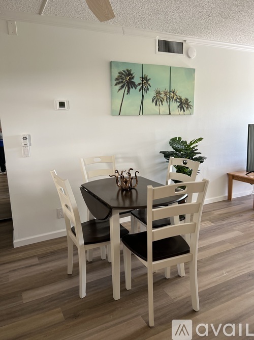 A dining room with a table and chairs.
